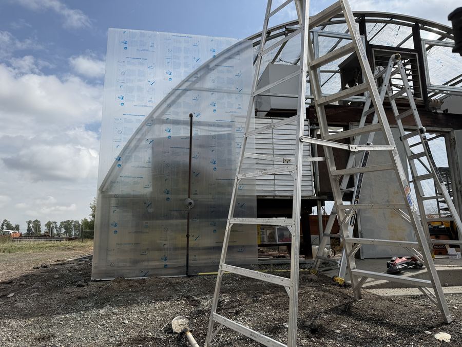 Mounting a curved 4-layer polycarbonate panel to a CatchSunlight high-tunnel frame during installation
